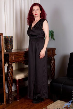 Zinnia Blue undresses to take doggy position photo 1