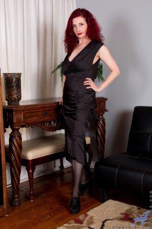 Zinnia Blue undresses to take doggy position photo 2
